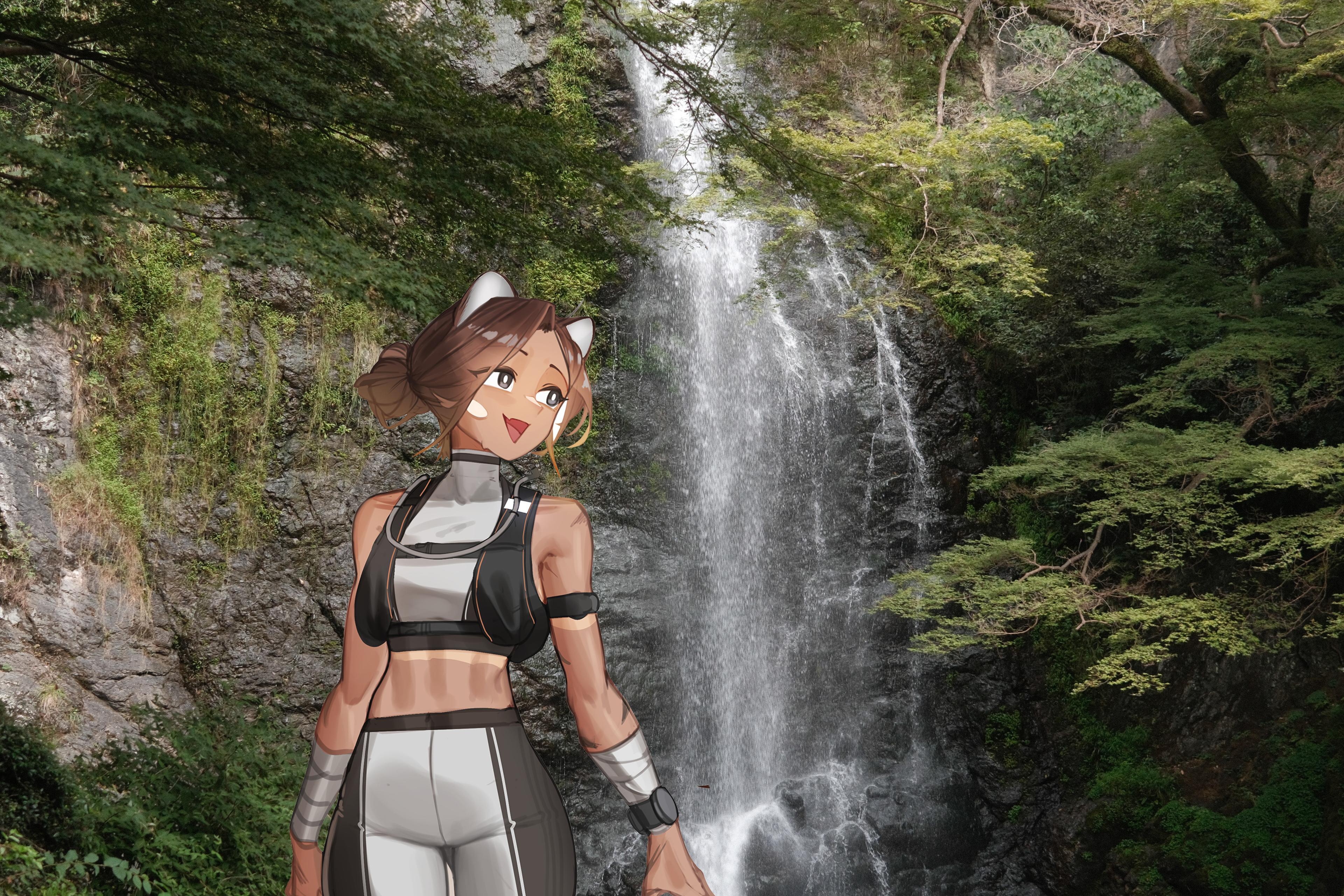Kiri grinning in front of a tall waterfall that pours down a dark, wet rock face, framed by green maple branches.